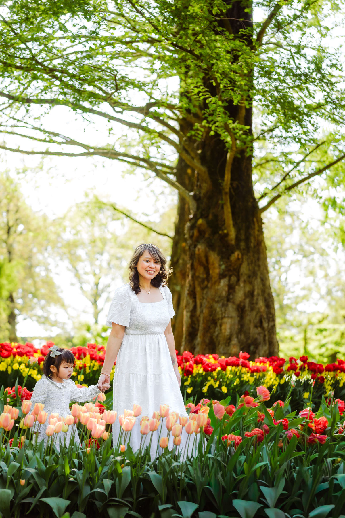 Mother and young daughter surrounded by colorful tulips at Keukenhof Gardens in the Netherlands