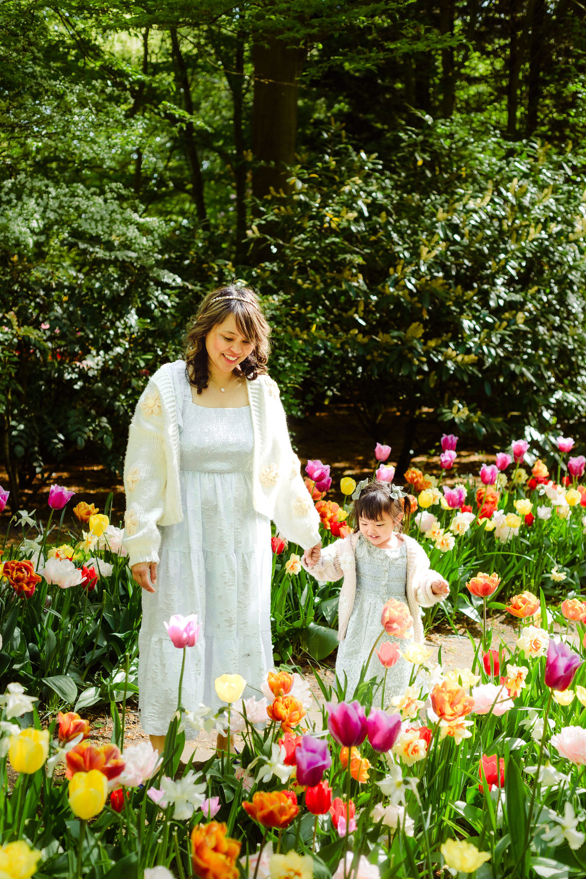 Mother and young daughter surrounded by colorful tulips at Keukenhof Gardens in the Netherlands