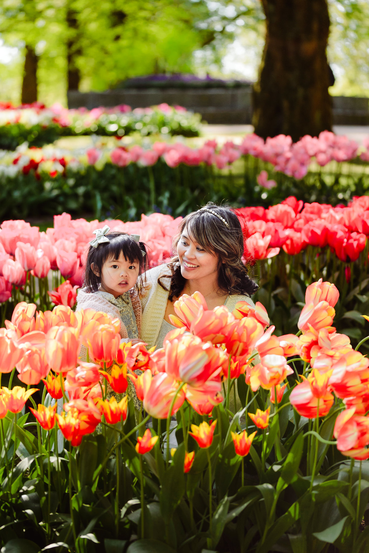 Mother and daughter walking together through colorful flower beds at Keukenhof