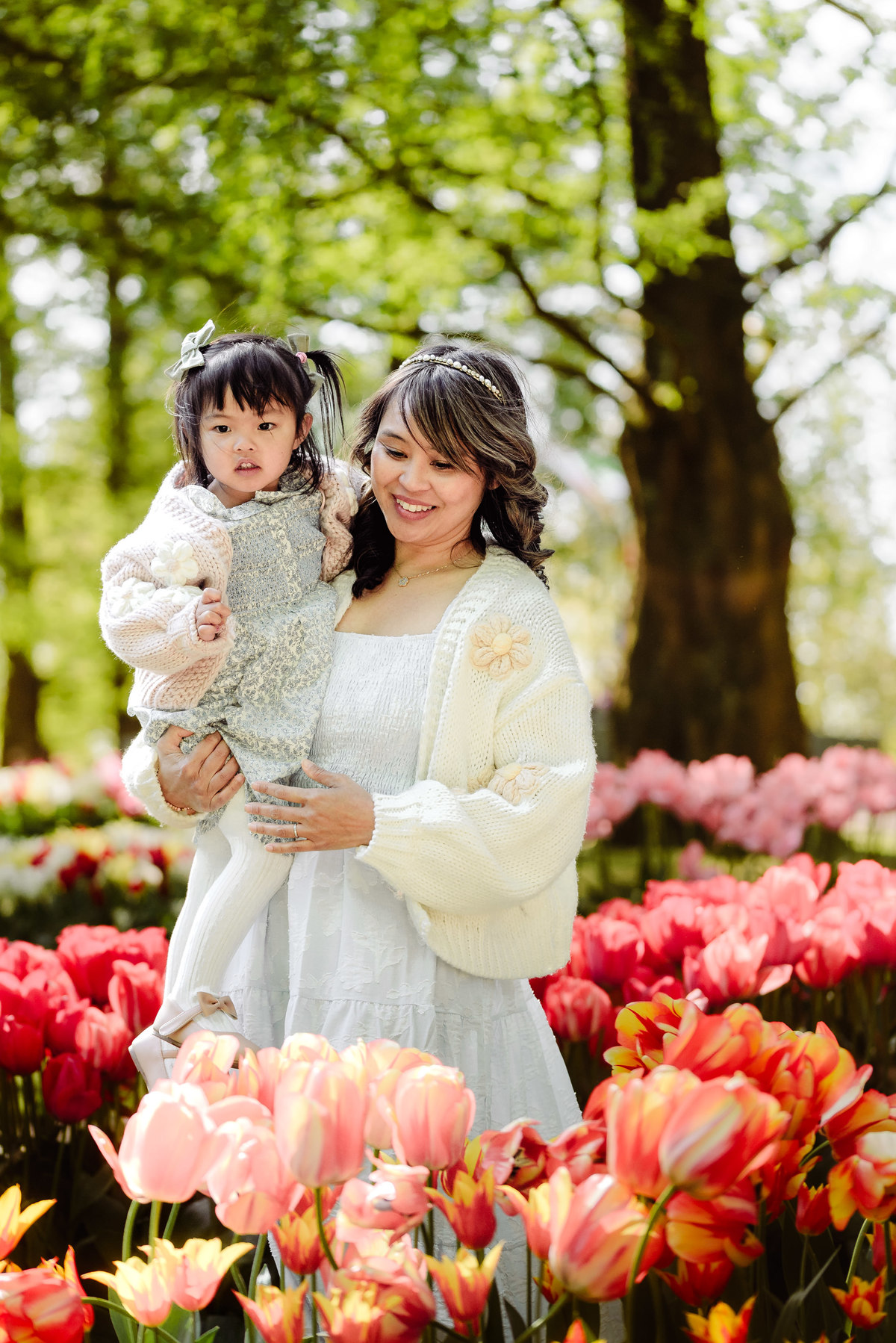 Mother and daughter walking together through colorful flower beds at Keukenhof
