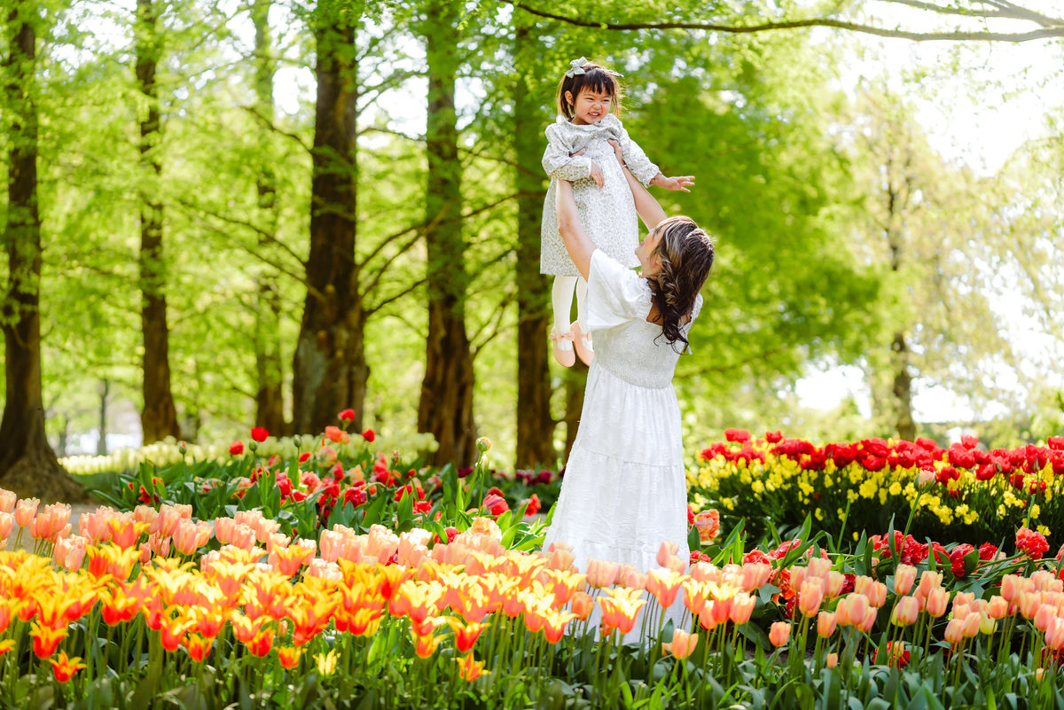 Mother and young daughter surrounded by colorful tulips at Keukenhof Gardens in the Netherlands
