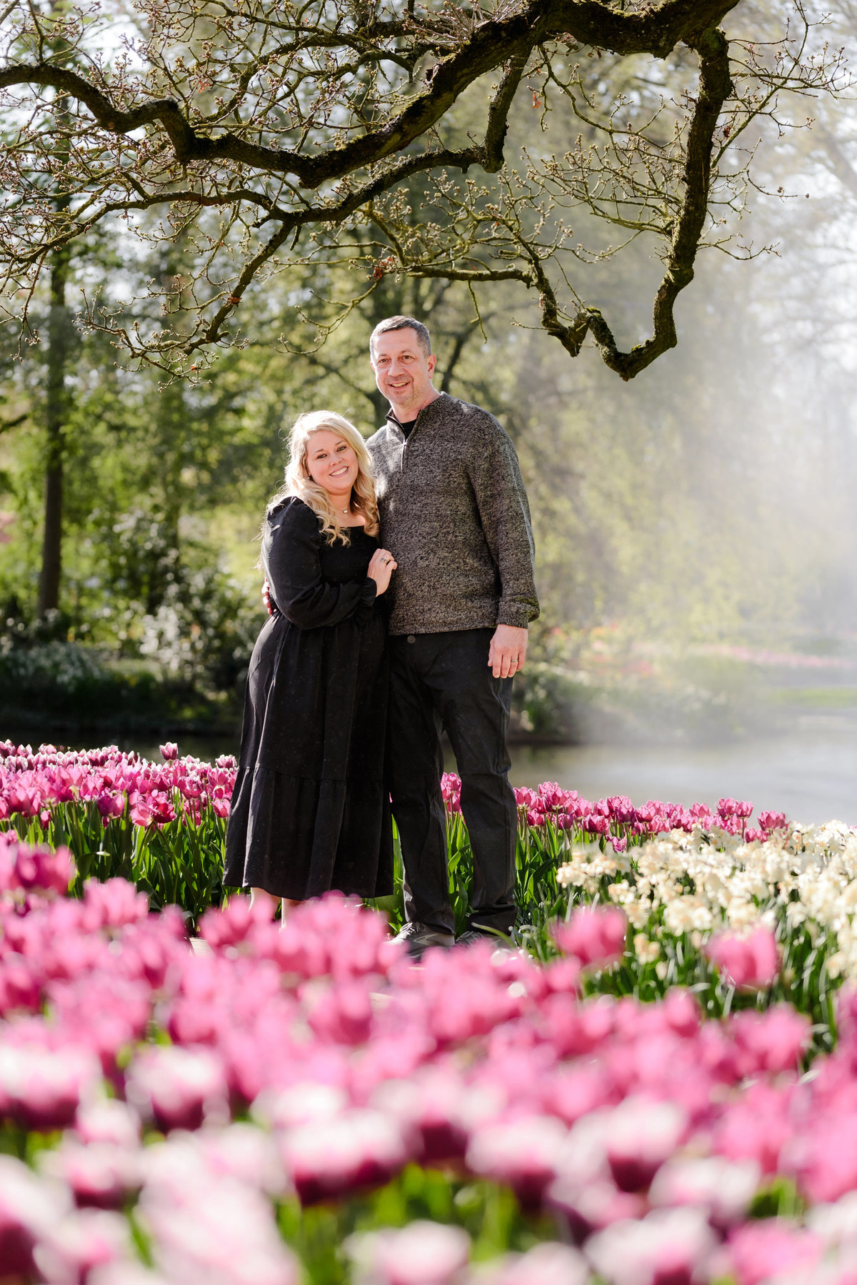 Couple exploring Keukenhof Gardens surrounded by colorful tulip displays