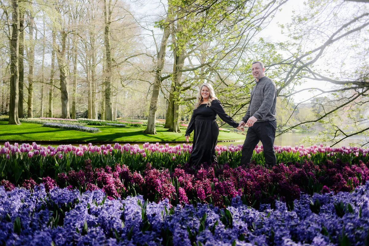 Couple exploring Keukenhof Gardens surrounded by colorful tulip displays