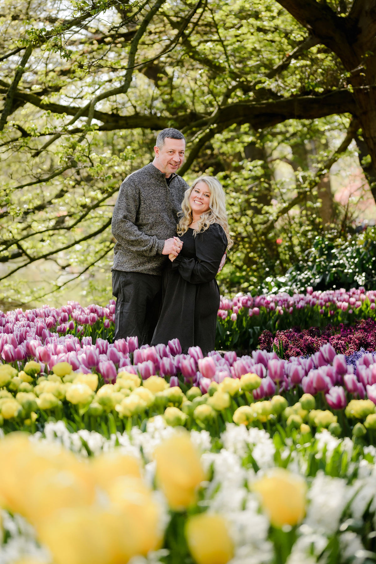 ouple portrait surrounded by spring flowers during tulip season