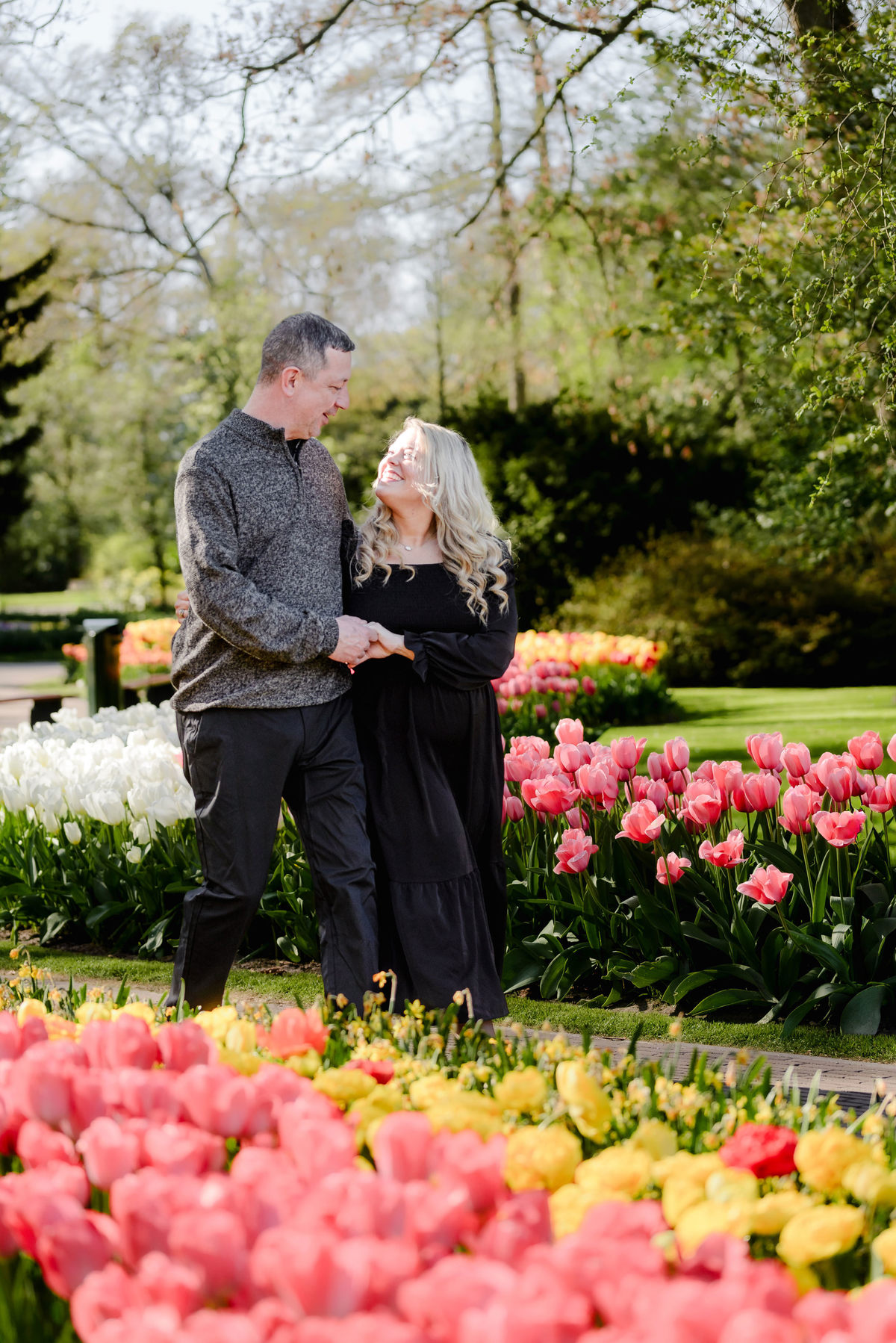 Couple exploring Keukenhof Gardens surrounded by colorful tulip displays