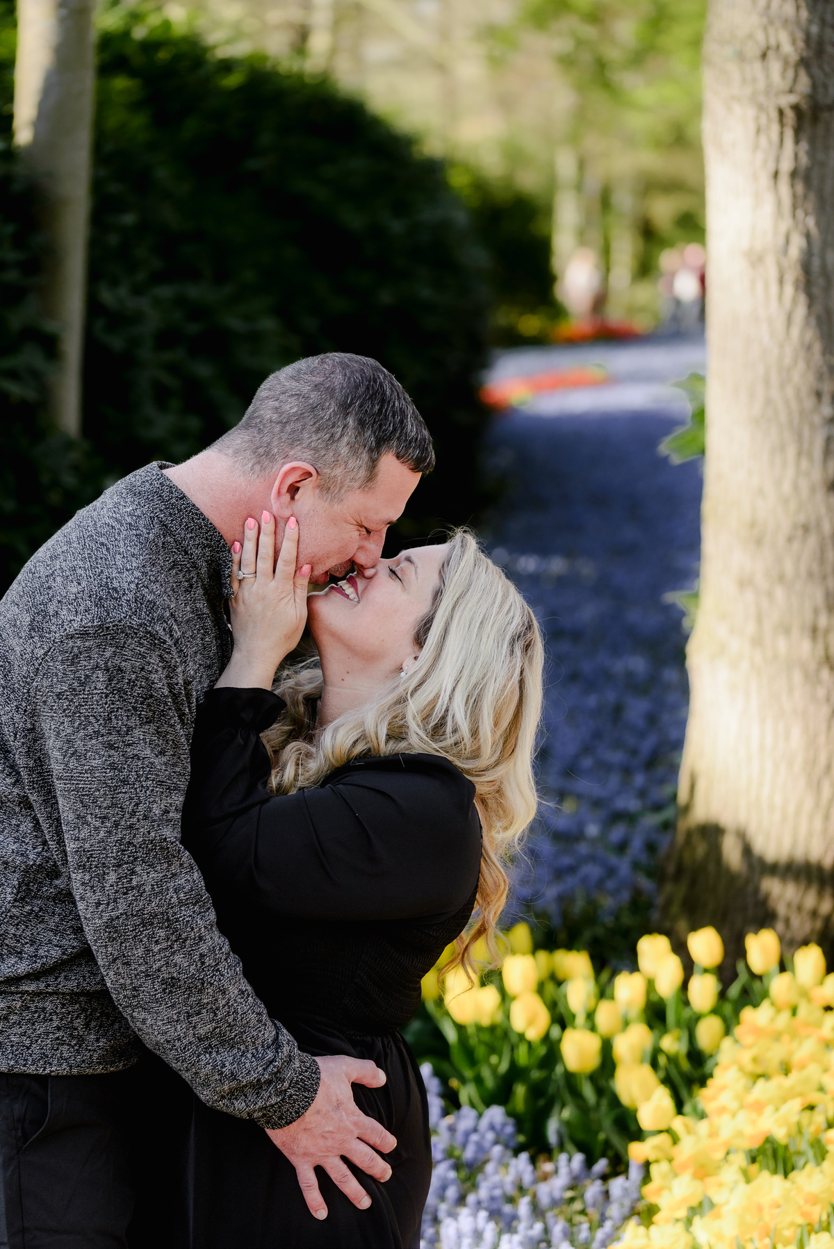 Couple sharing a quiet moment among spring flowers at Keukenhof Gardens