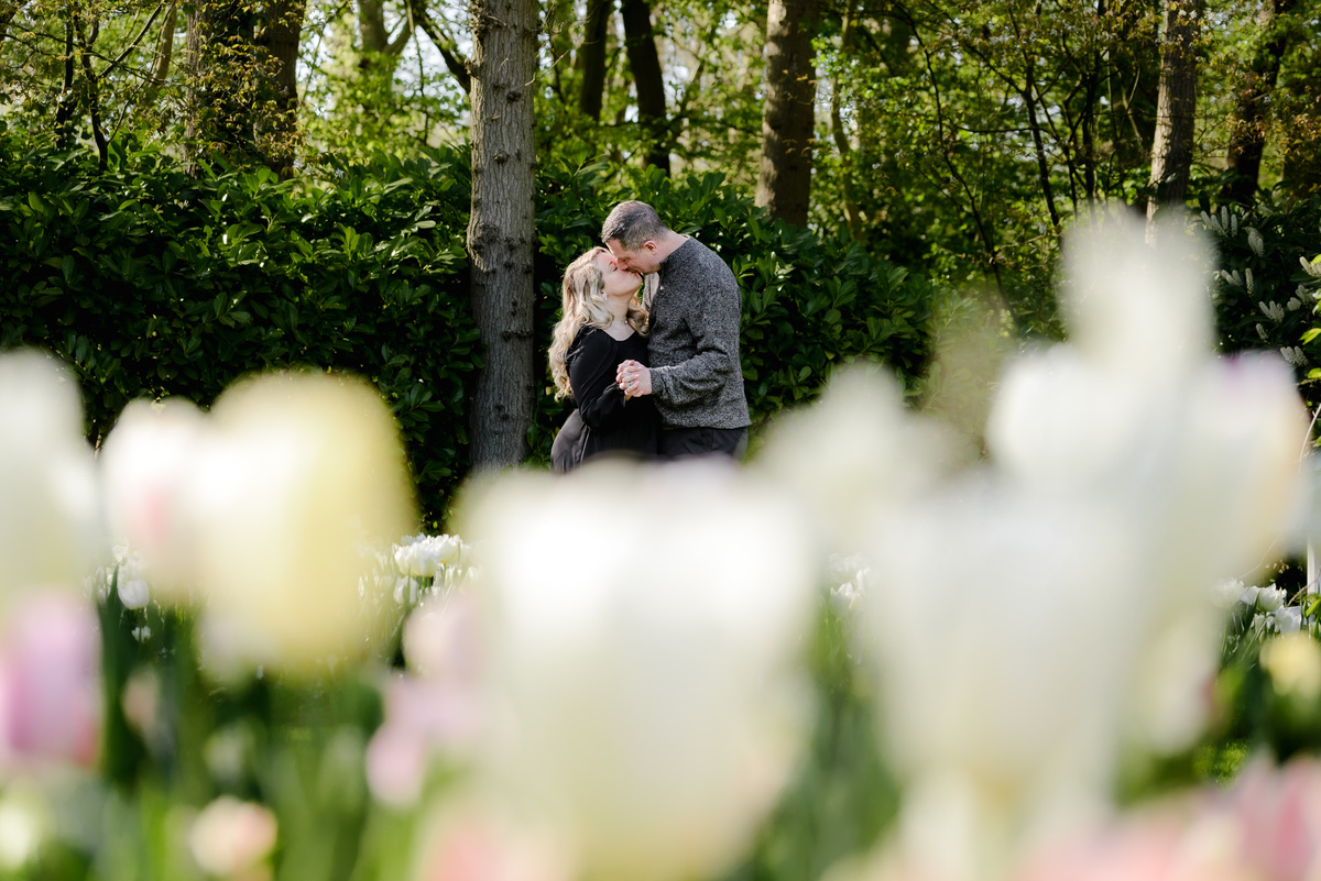 Couple sharing a quiet moment among spring flowers at Keukenhof Gardens