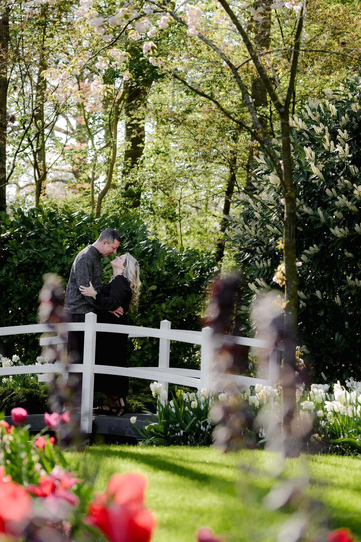 Couple sharing a quiet moment among spring flowers at Keukenhof Gardens