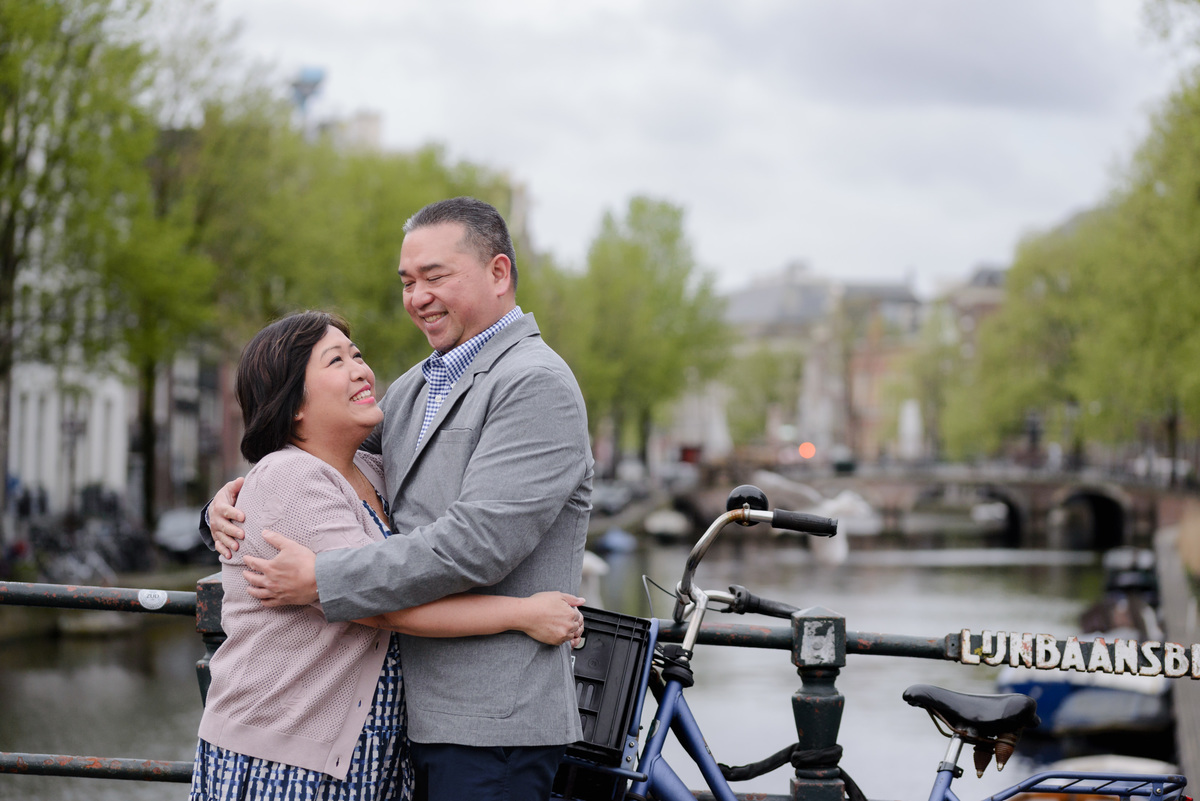 Couple embracing beside a canal in Amsterdam