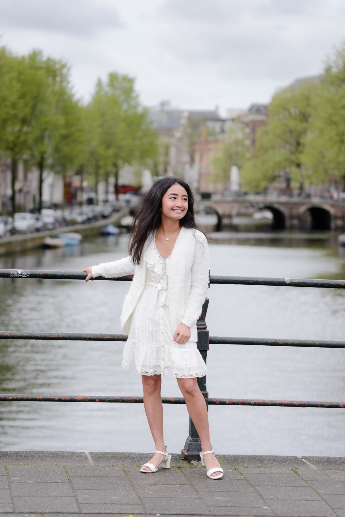 Portrait of a young woman overlooking a canal in Amsterdam