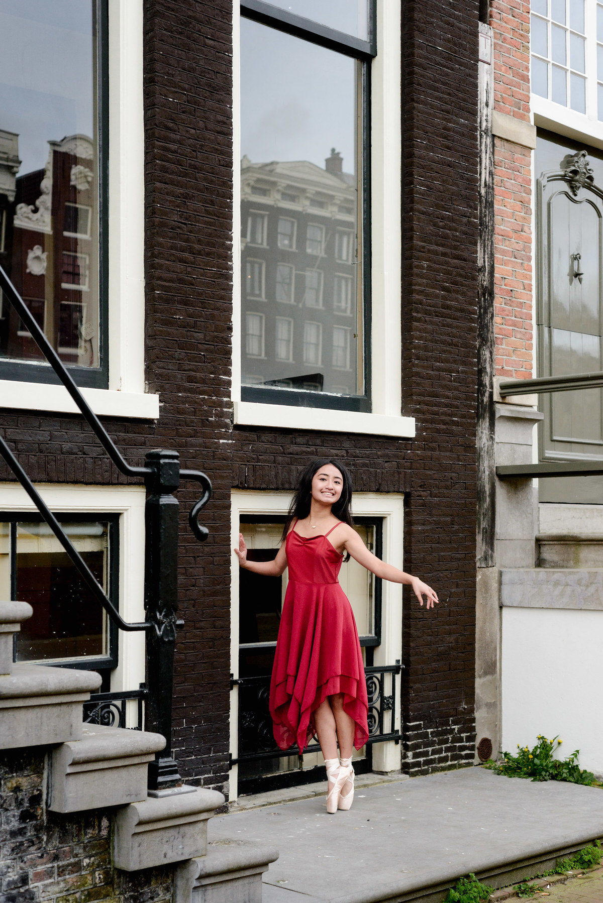 Young dancer wearing a red dress during a photography session in Amsterdam