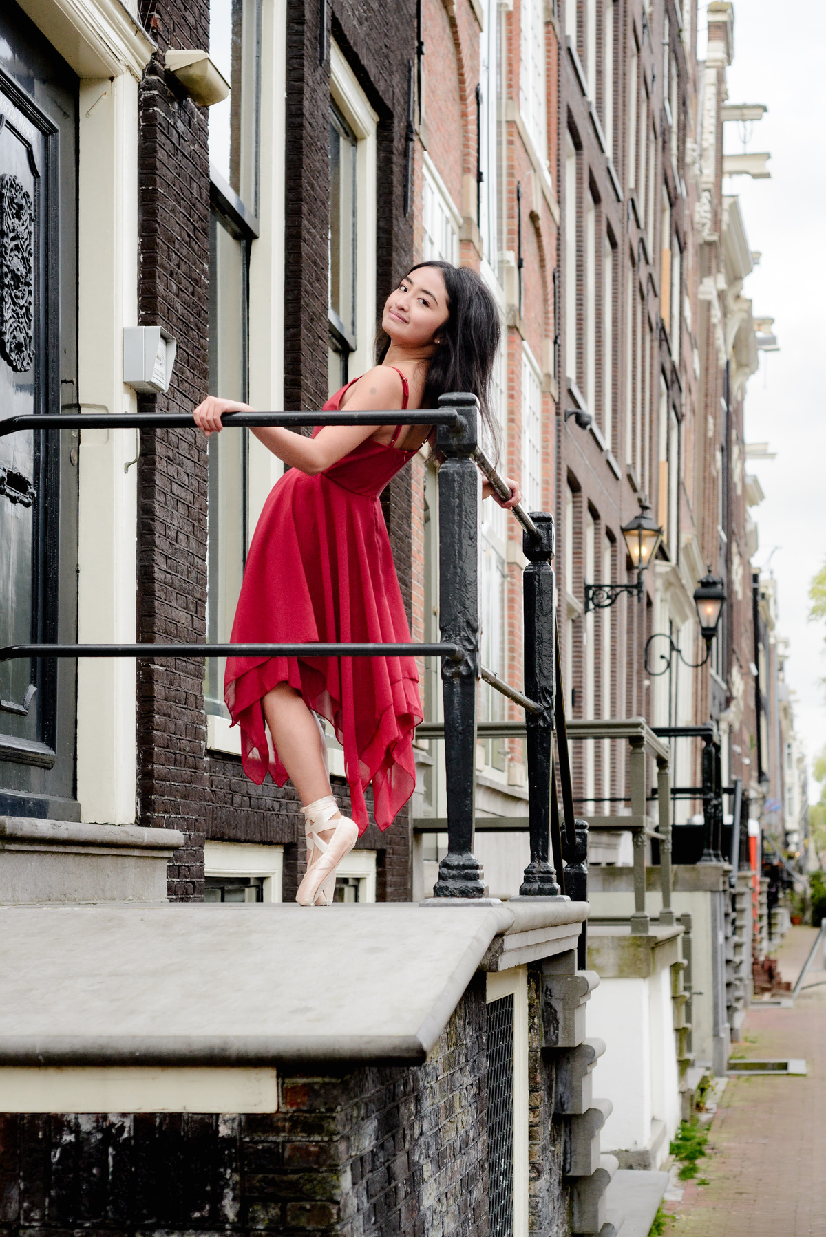Young dancer wearing a red dress during a photography session in Amsterdam