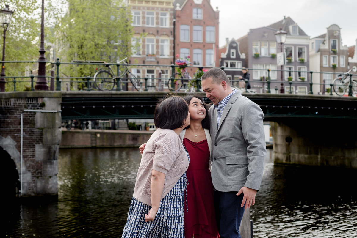 Family photography session on a canal bridge in Amsterdam