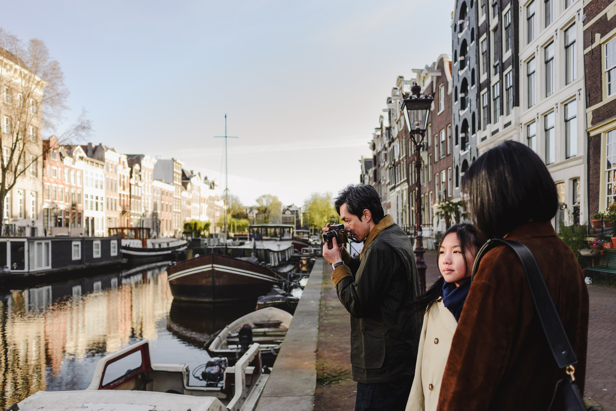 Family exploring the canals of Amsterdam together