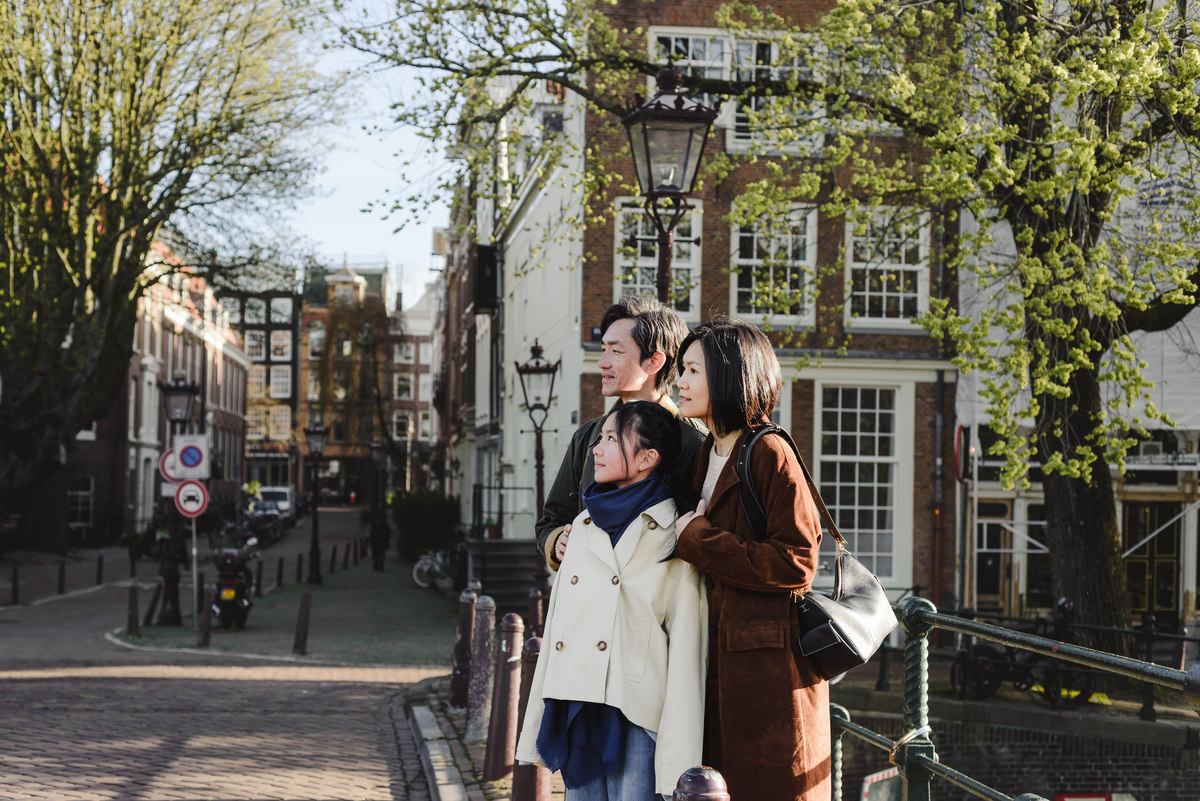 Family walking along a canal in Amsterdam
