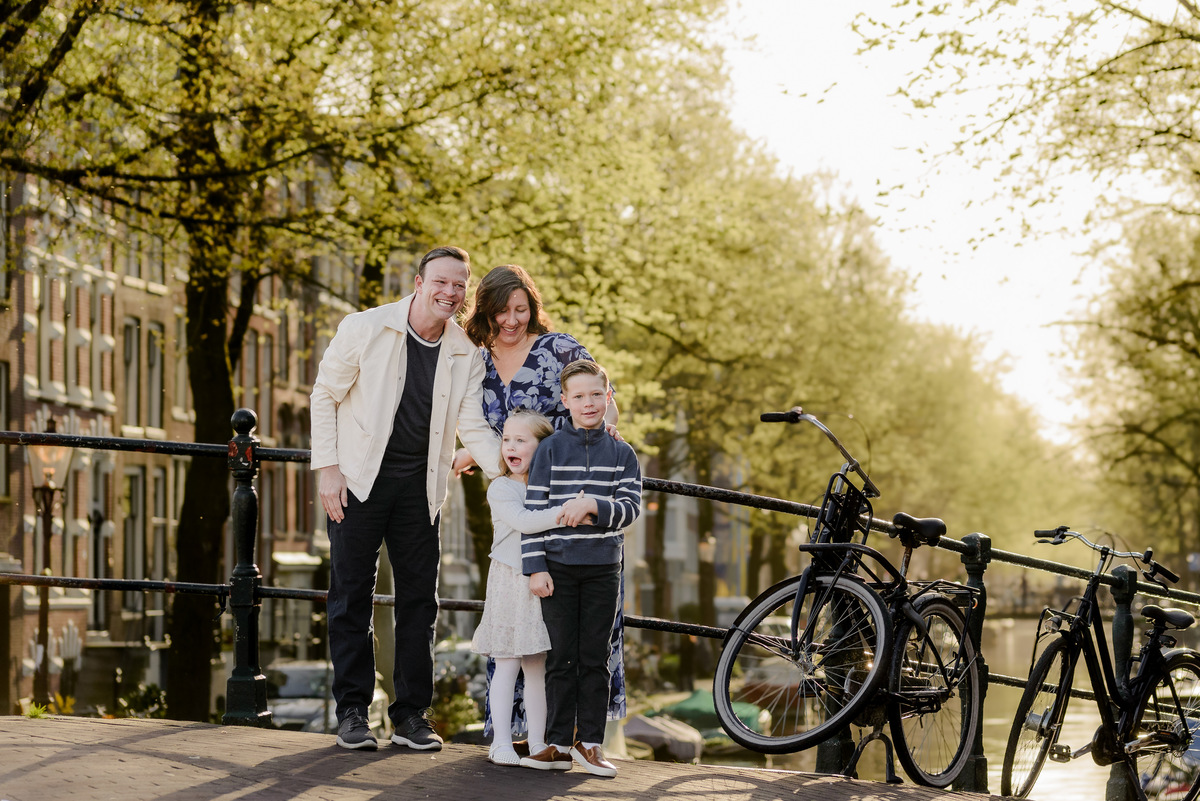 Family sharing a moment together beside a canal in Amsterdam's Jordaan neighborhood