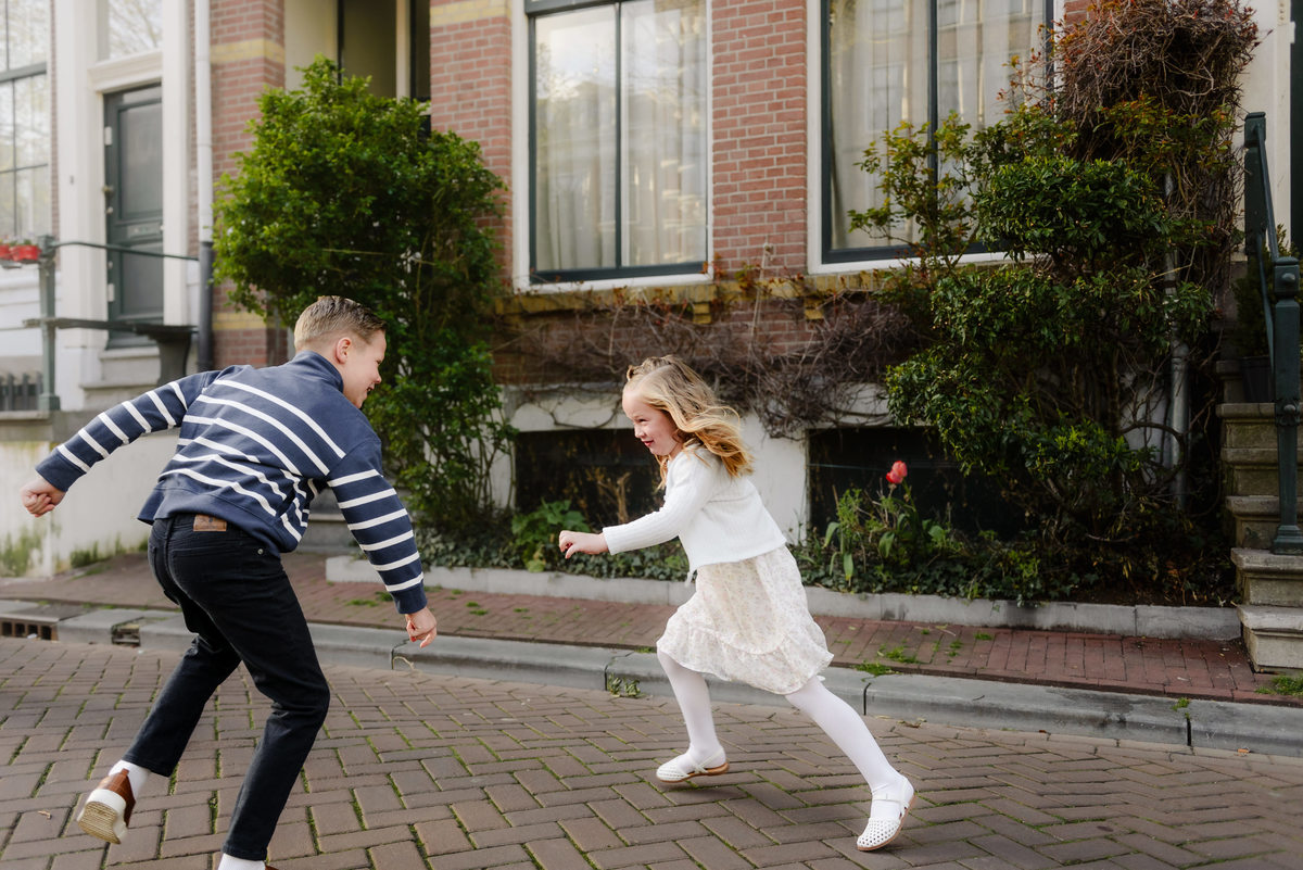 Children running and playing together on a quiet Amsterdam street