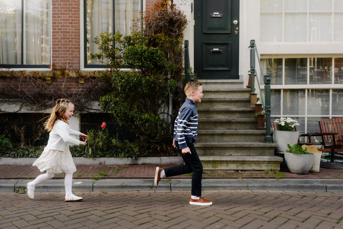Children running and playing together on a quiet Amsterdam street
