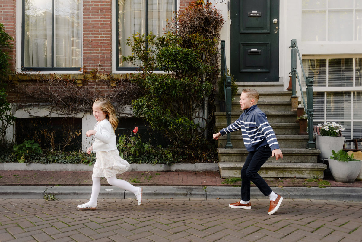 Children running and playing together on a quiet Amsterdam street