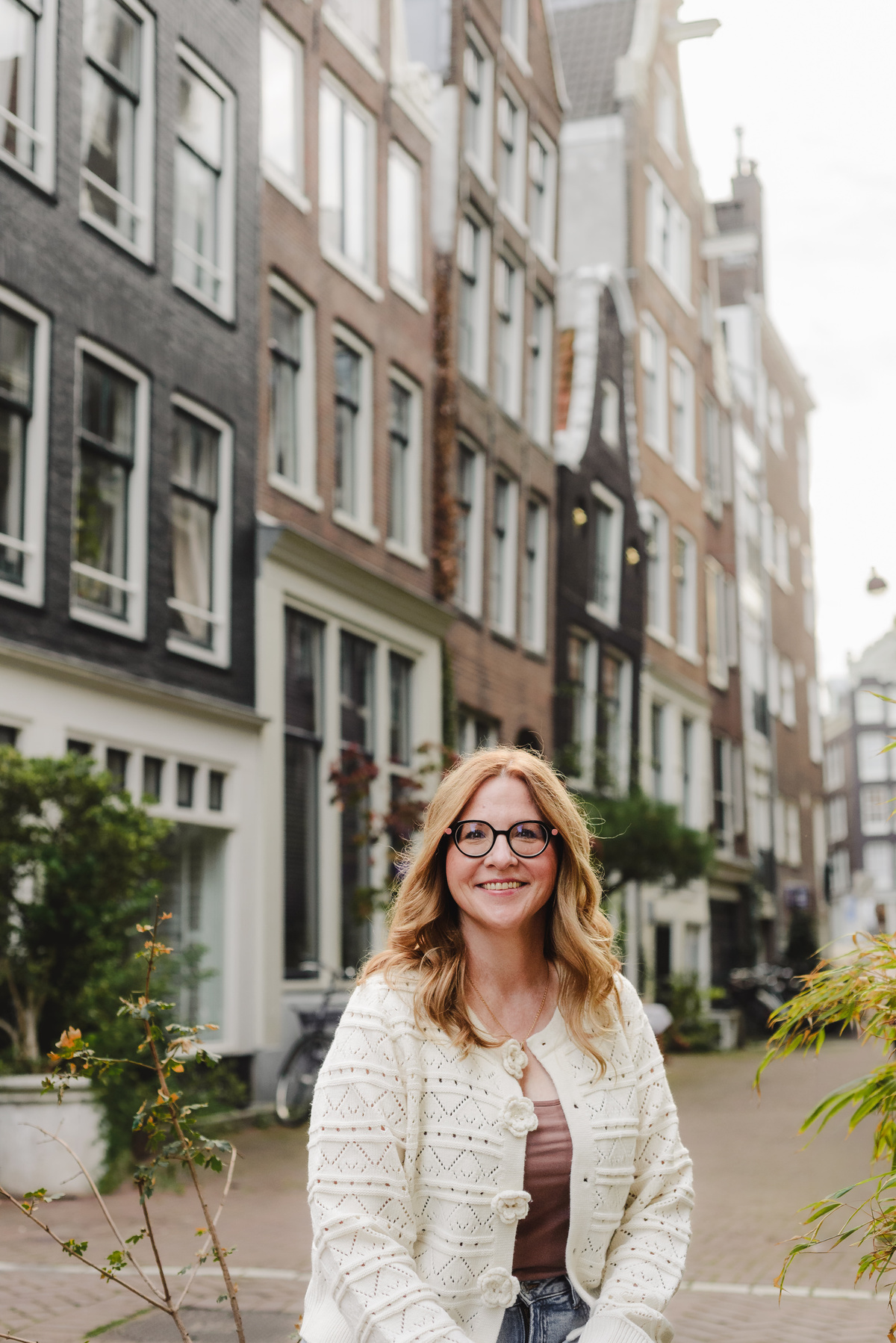 Business portrait capture during the vacation in Amsterdam. This is a female business owner, a travel agent specializing in river cruises, photographing her trip in Amsterdam. 