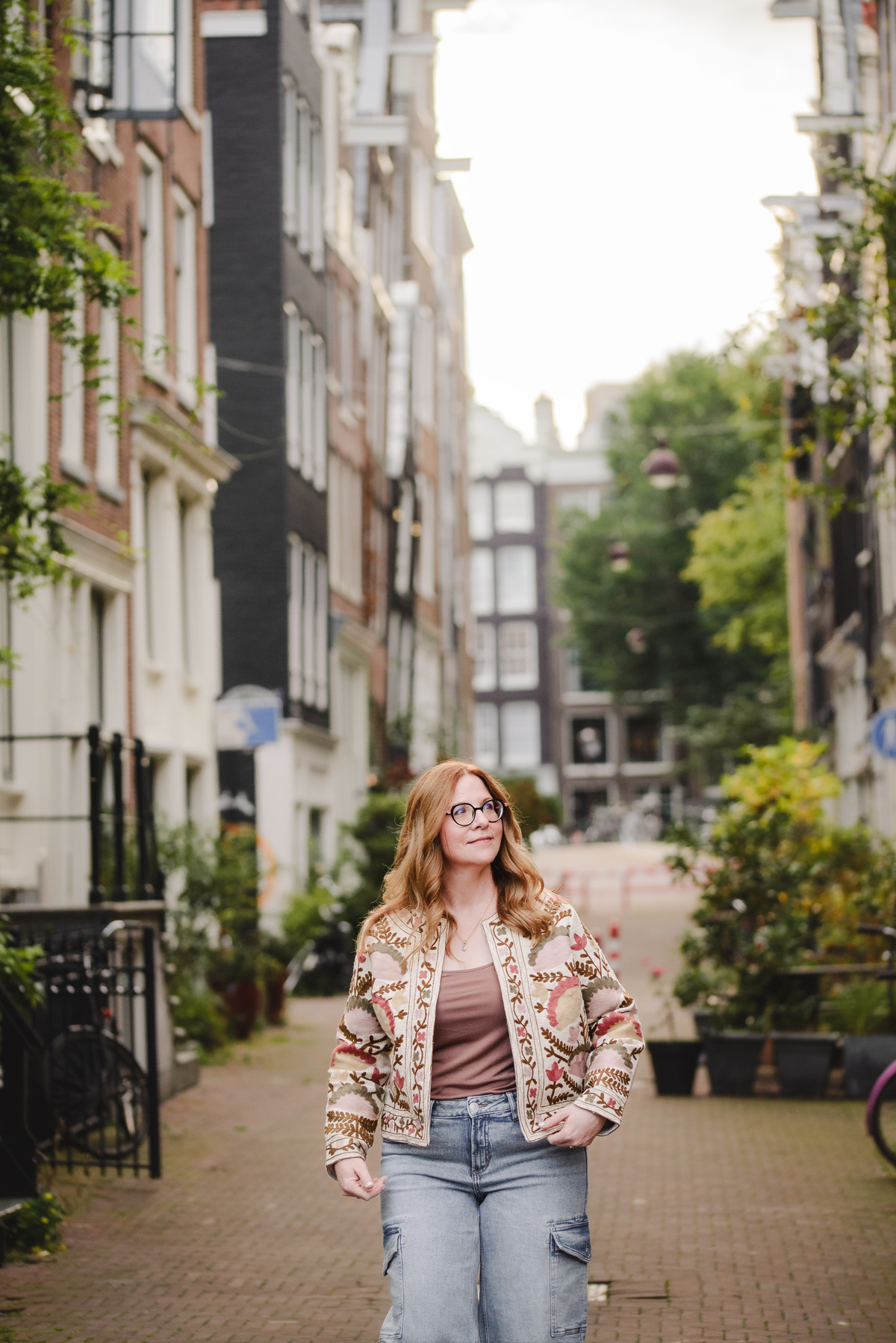 Business owner walking down the streets of Amsterdam during a quiet morning as part of her vacation photography experience as a travel advisor visiting Amsterdam 