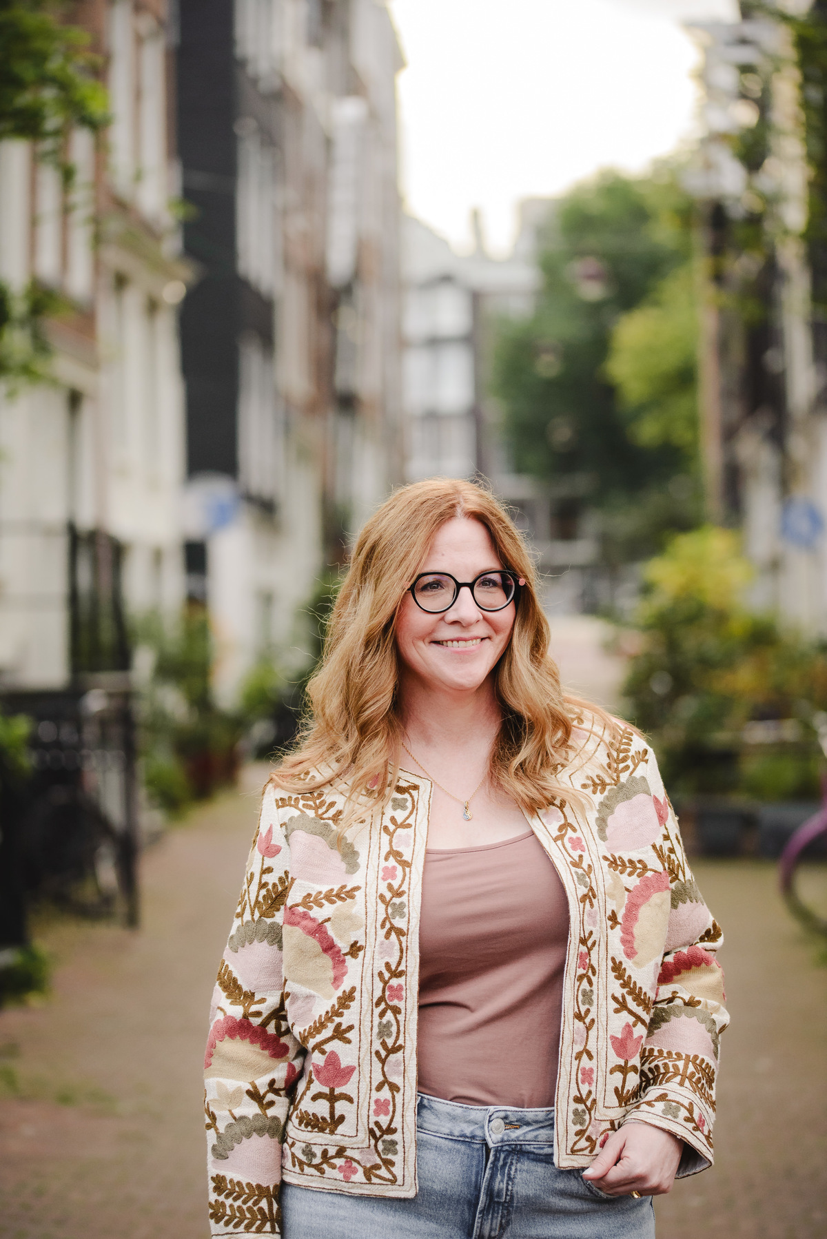 Female business owner capturing her business portraits in a quiet street in Amsterdam. This was a part of her vacation photography during a quiet morning in Amsterdam