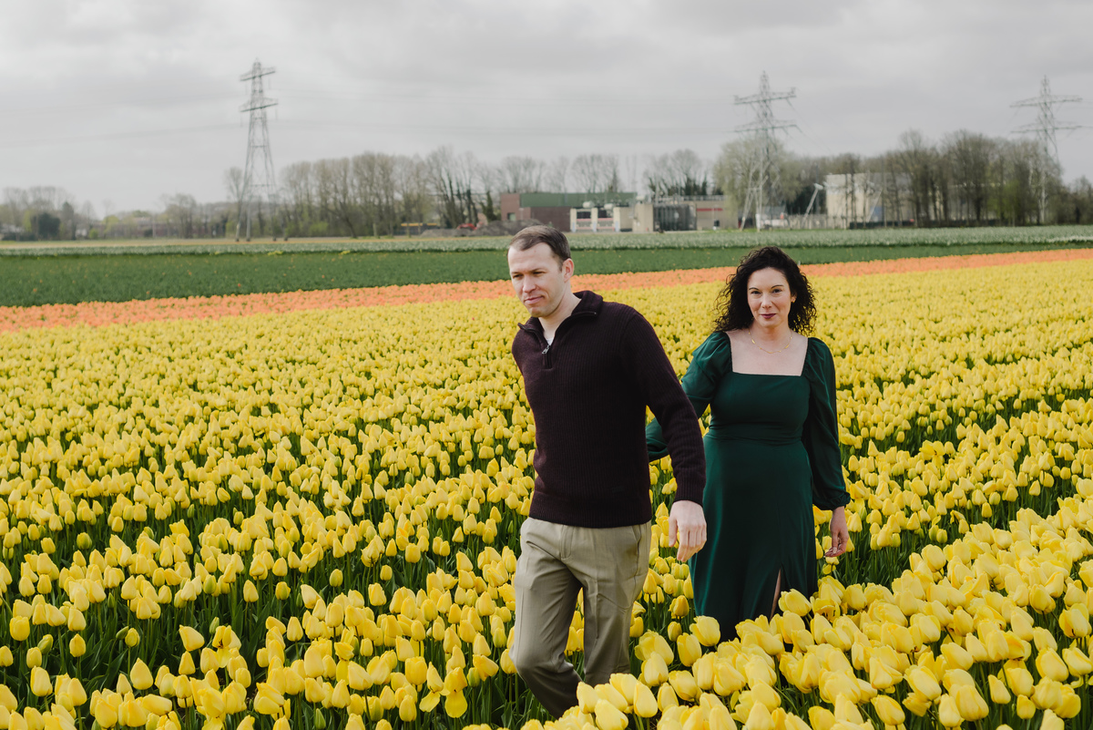 Couple standing together in the Dutch tulip fields during a spring photo session.