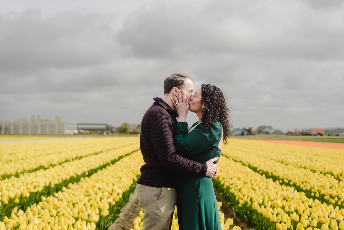 Couple embracing in a private tulip field during spring.