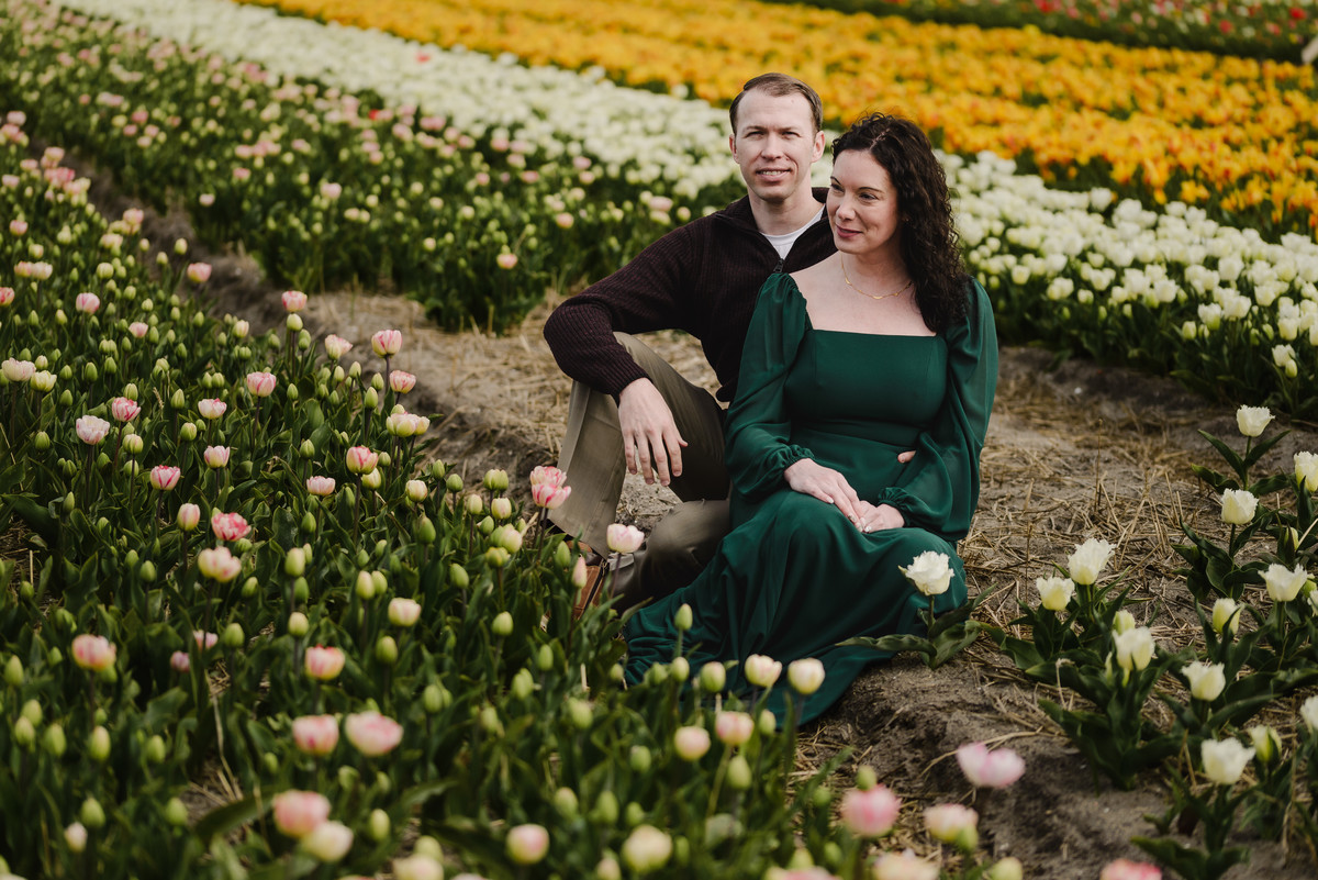 Portrait framed by blooming tulips in the foreground.