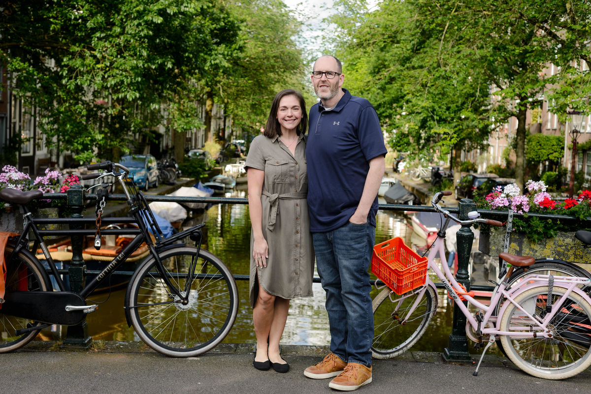 Couple walking hand in hand through the historic streets of Amsterdam