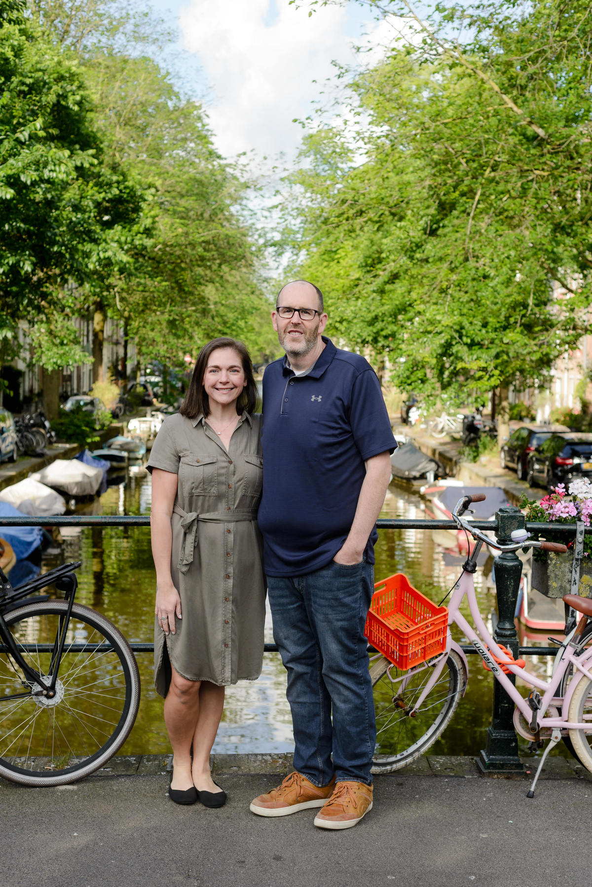 Parents smiling together by the canals during an Amsterdam photography session.
