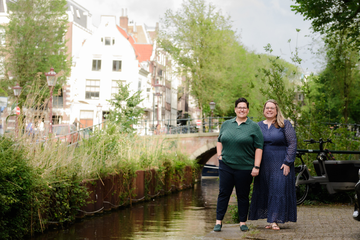Couple laughing together while exploring Amsterdam's canal district.