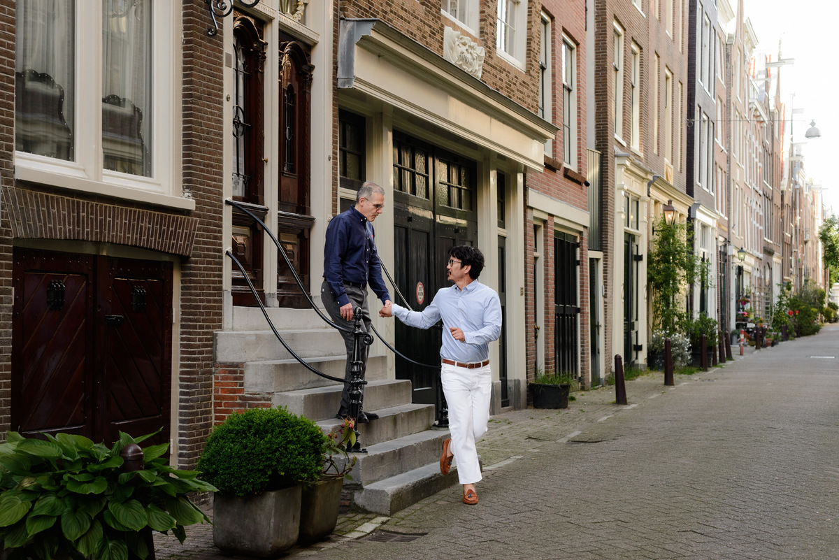 Couple enjoying a quiet walk through Amsterdam's historic centre.