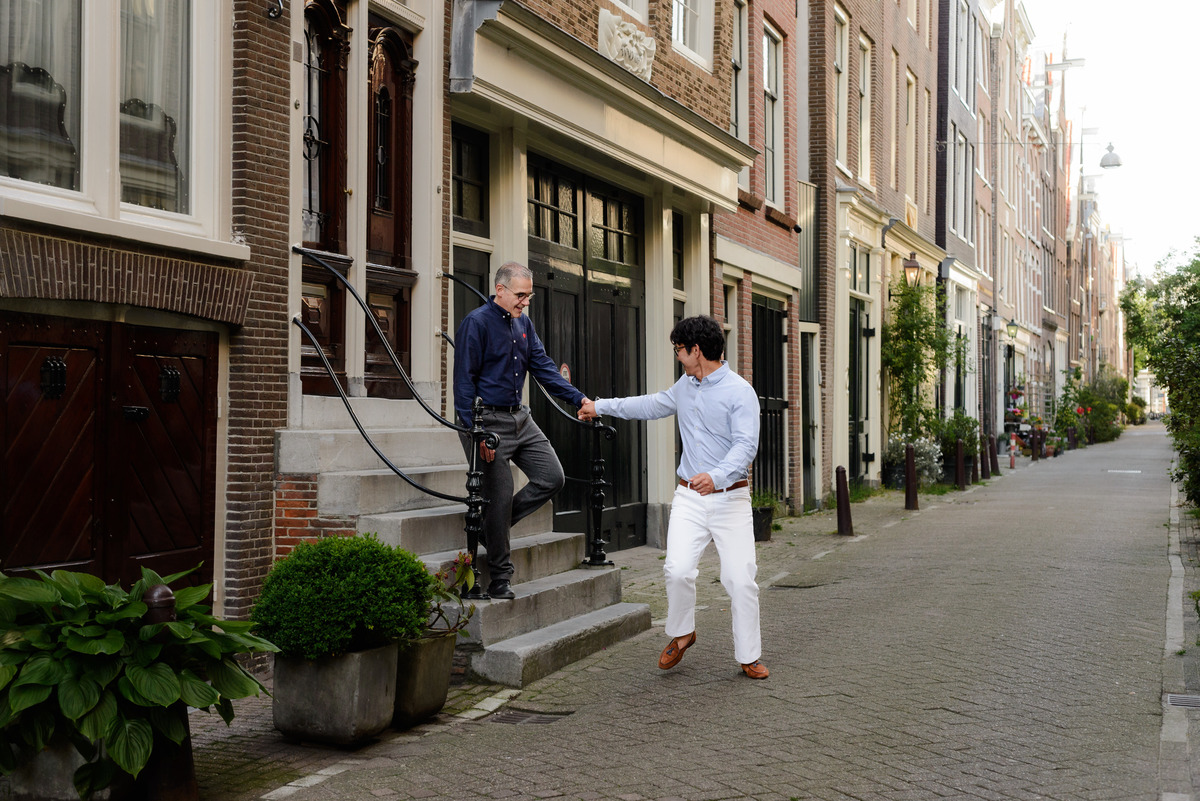 Natural portrait of a couple walking through Amsterdam's historic streets.