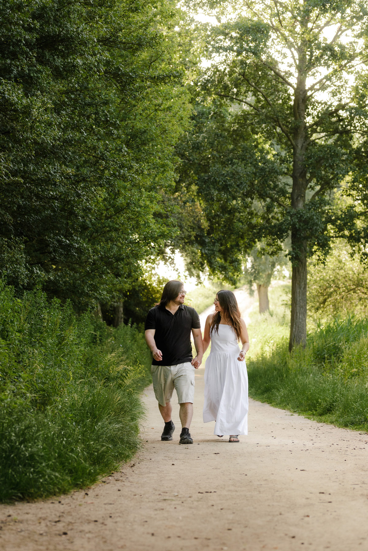 Candid engagement portrait surrounded by nature in Westerpark.