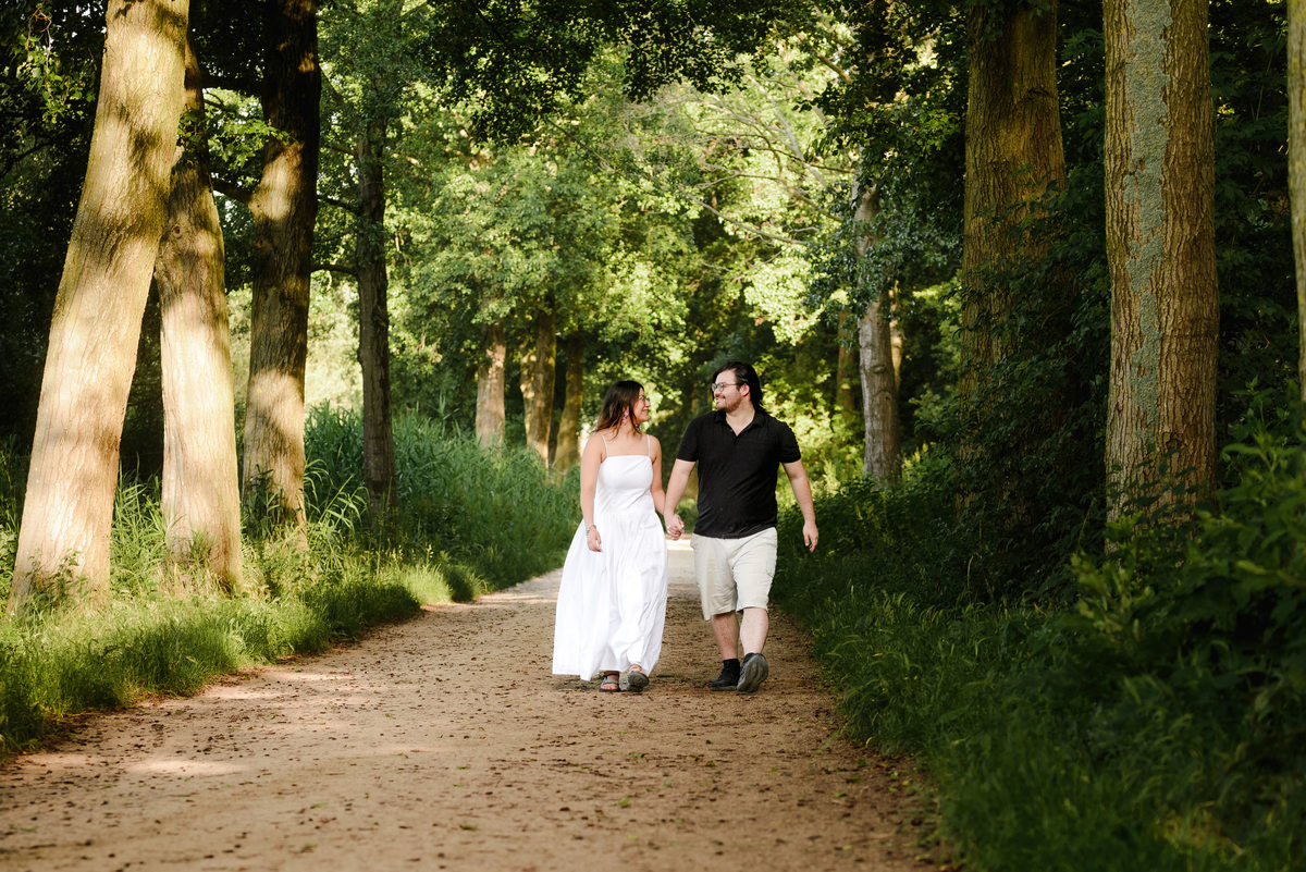 Candid engagement portrait surrounded by nature in Westerpark.
