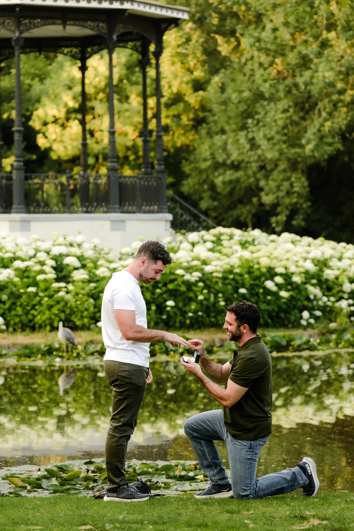Partner getting down on one knee during a surprise proposal in Amsterdam.