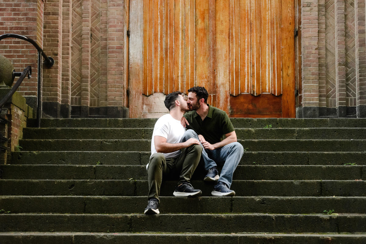 Joyful newly engaged couple celebrating in Vondelpark, Amsterdam.
