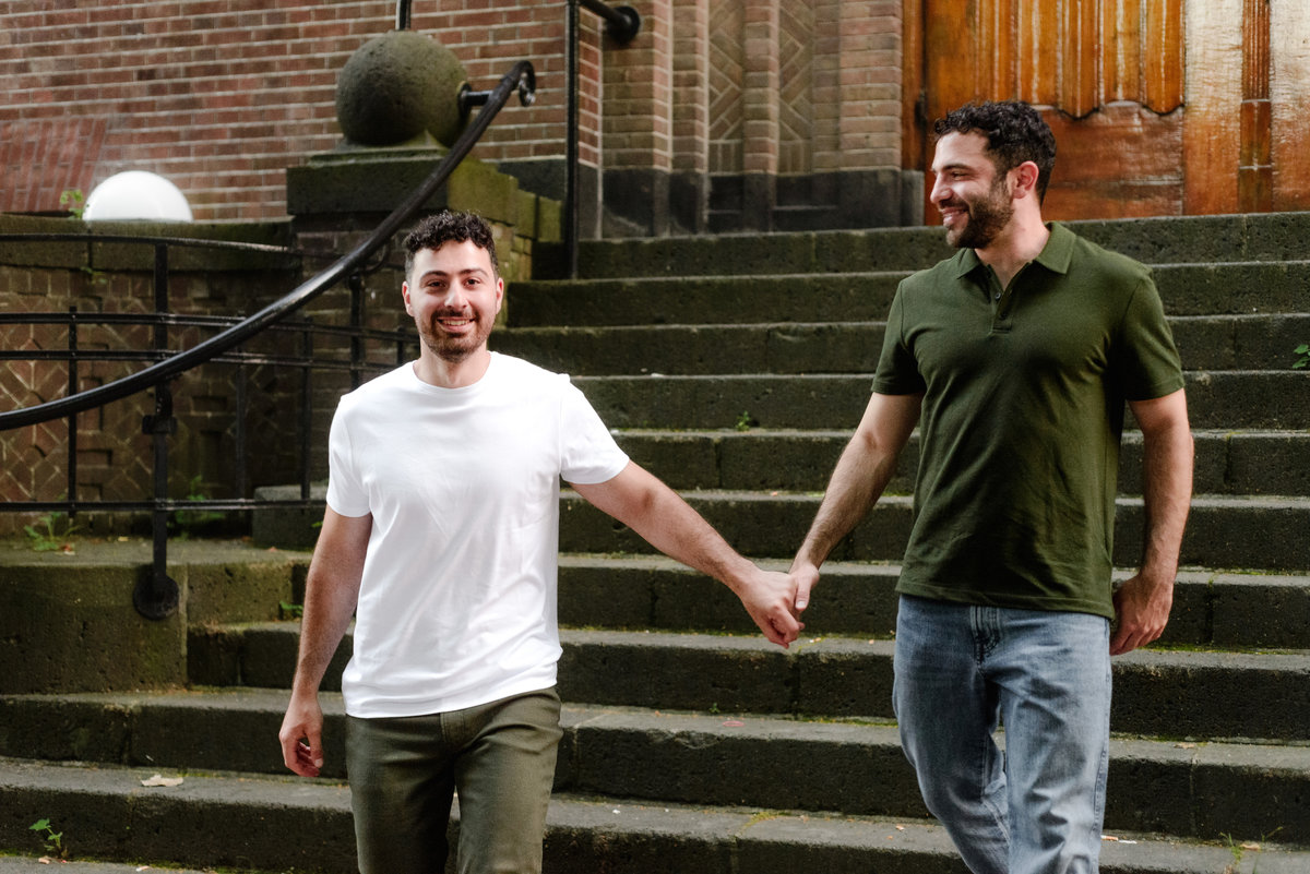 Joyful newly engaged couple celebrating in Vondelpark, Amsterdam.