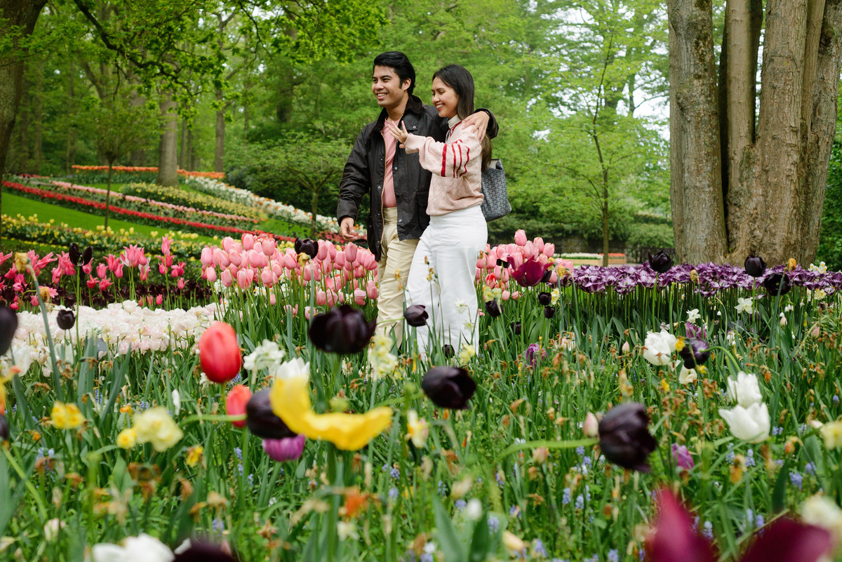 Newly engaged couple celebrating at Keukenhof Gardens.