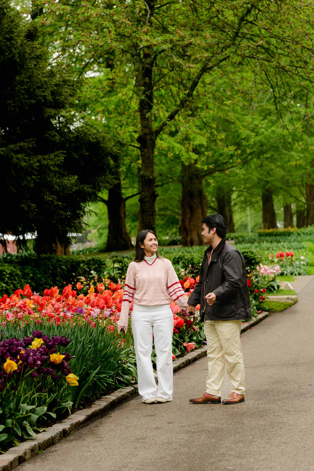 Couple walking together through Keukenhof after their proposal.