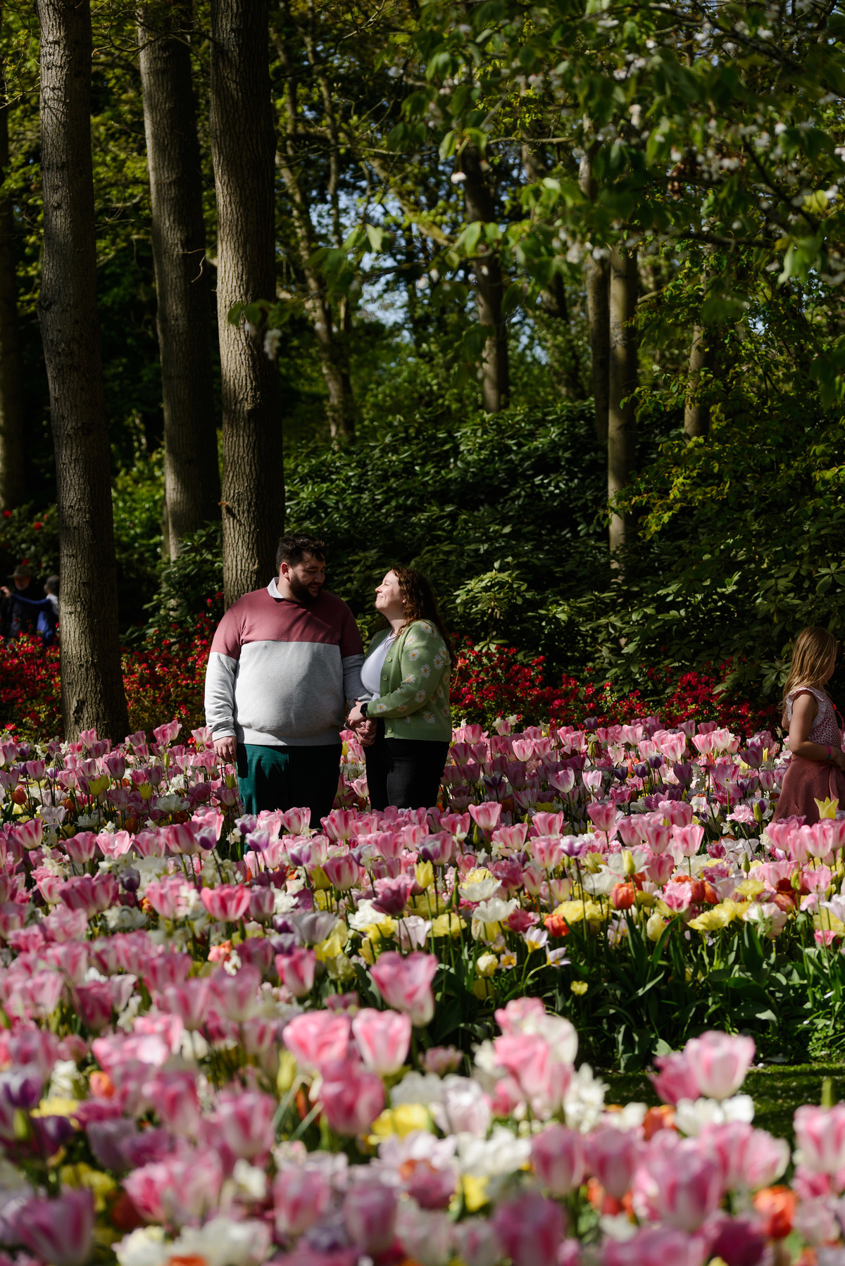 Romantic portraits with vibrant spring flowers in the background.