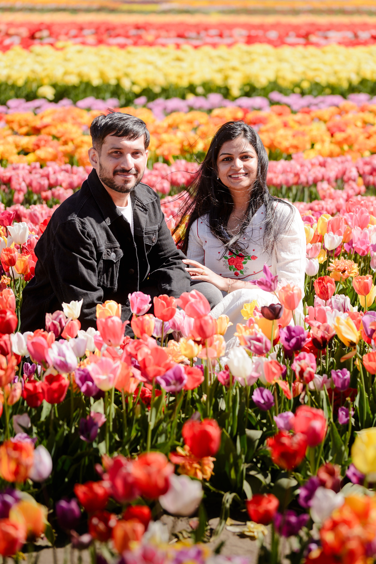 Natural anniversary portraits surrounded by colourful tulips.