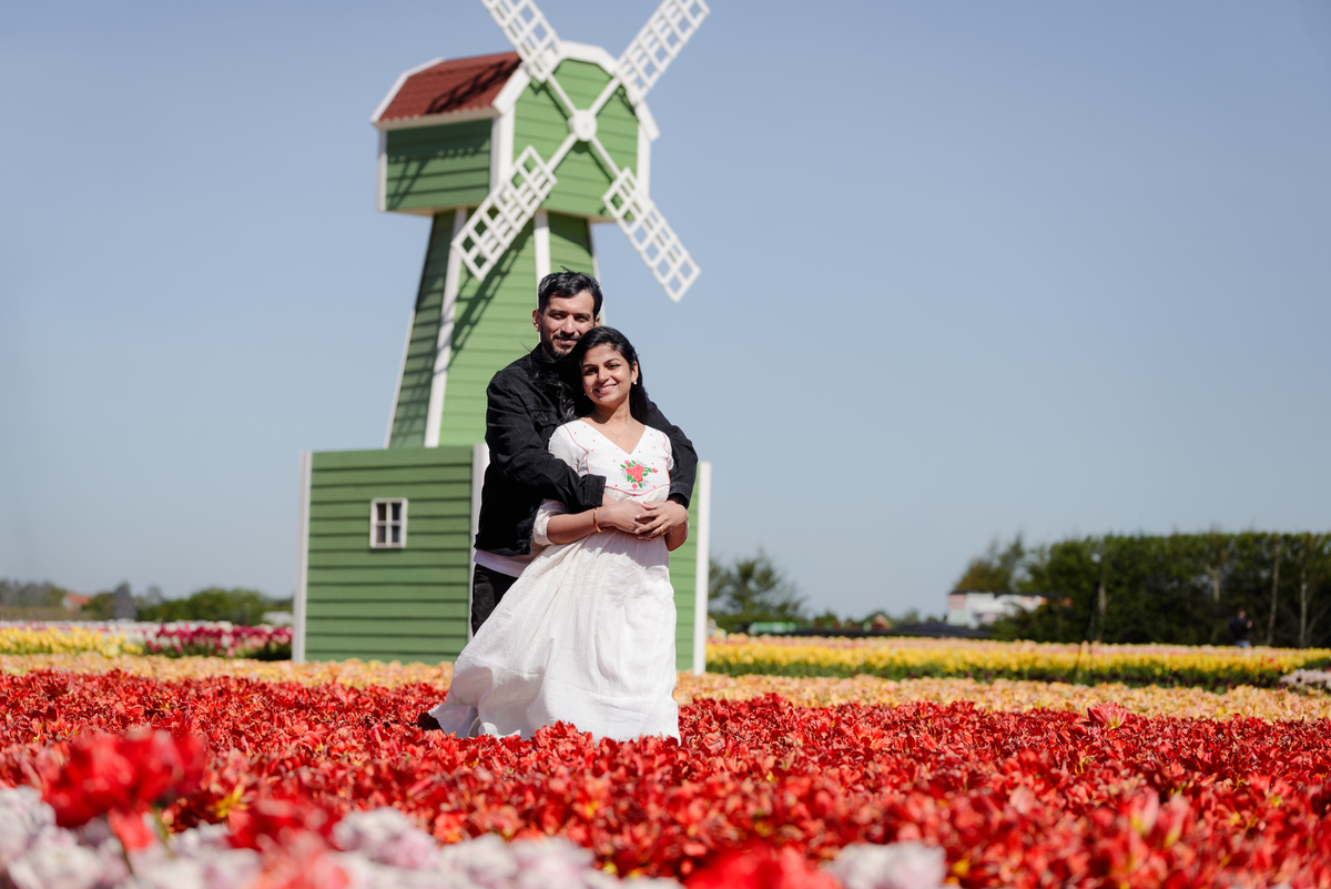 Natural anniversary portraits surrounded by colourful tulips.