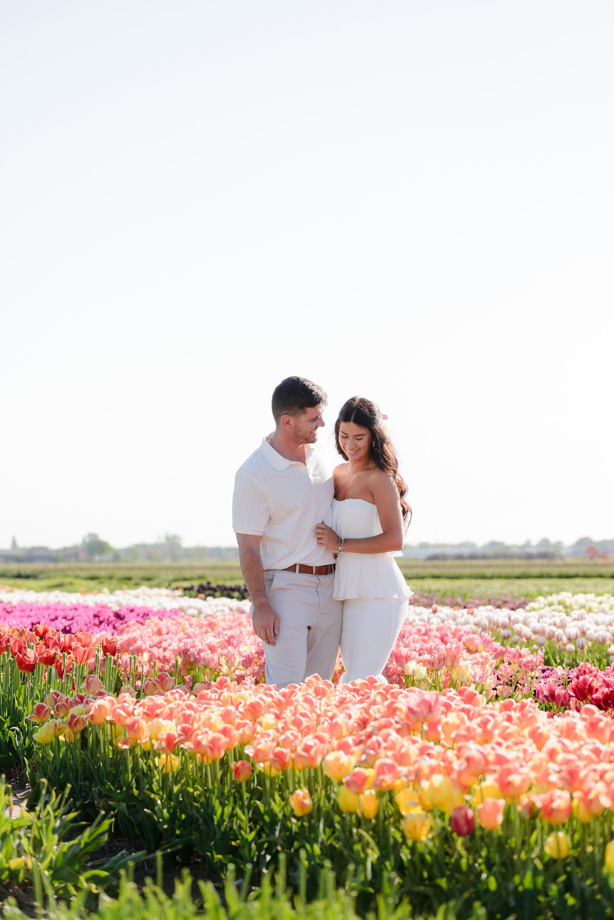 Surprise proposal surrounded by colourful tulips at Tulip Experience Amsterdam.