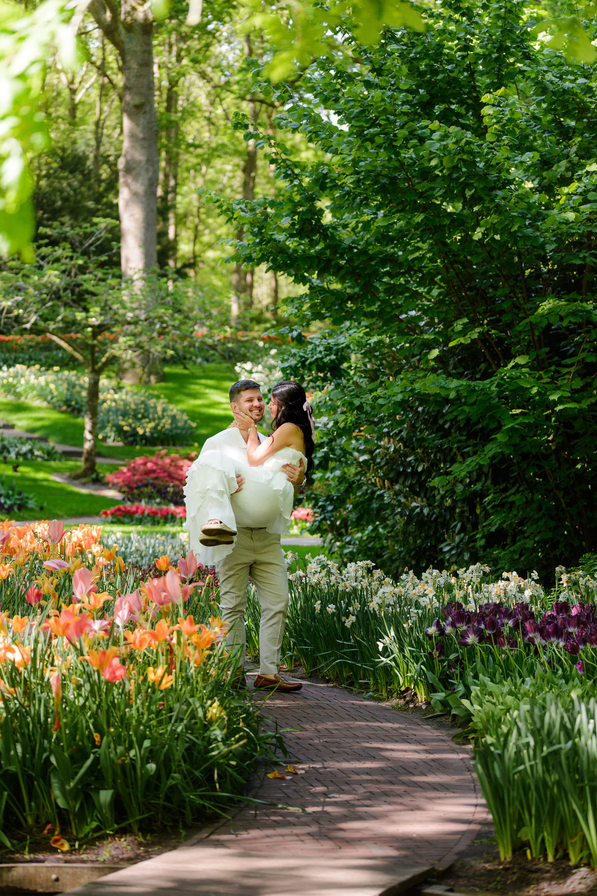 Couple walking together through Keukenhof Gardens after their engagement.