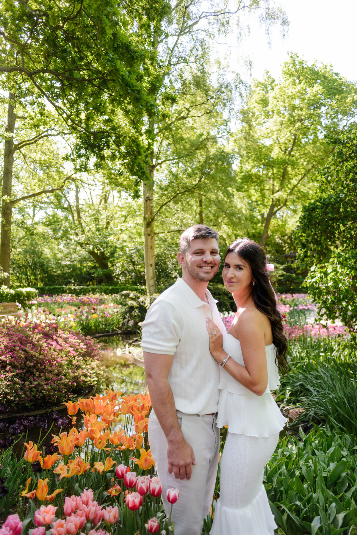 Joyful engagement portraits surrounded by spring flowers at Keukenhof.
