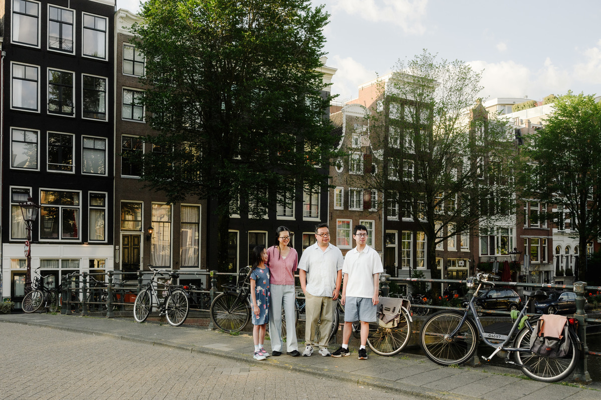 Family exploring Amsterdam's canals together.