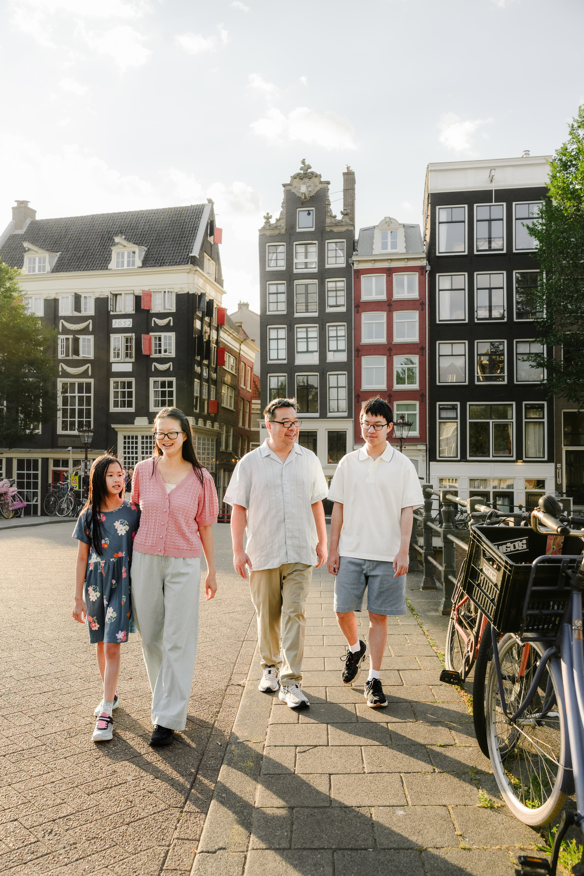Natural family portrait on a canal bridge in Amsterdam.