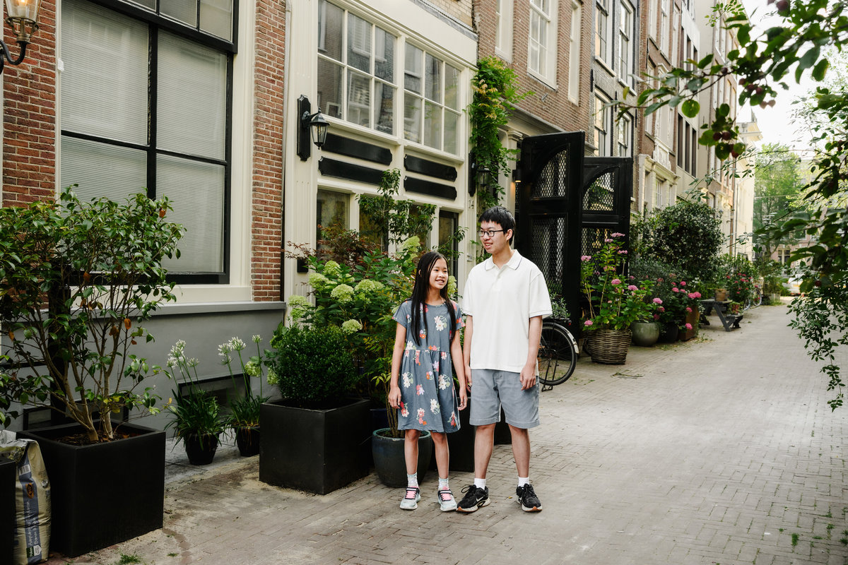Children laughing while exploring Amsterdam with their parents.